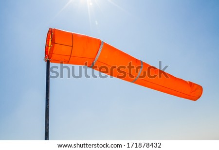 Bright orange wind direction under blue sky
