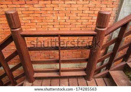 Wood stair and brick wall