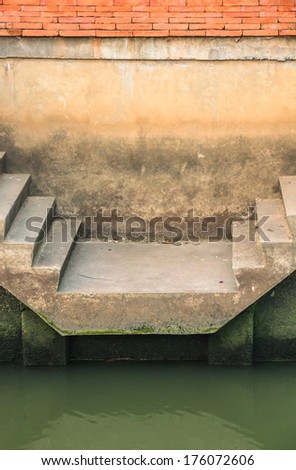 Cement stair on green river