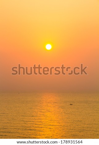 Sun and sea on golden sky background