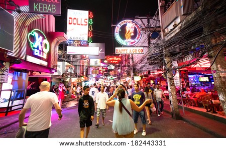 PATTAYA - MARCH 15: Crowd walking through the Walking Street on March 15, 2014 in Pattaya, Thailand. Its a tourist attraction primarily for night life and entertainment