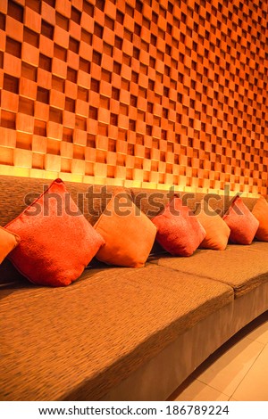 Silk pillow on soft sofa and wood cube wall