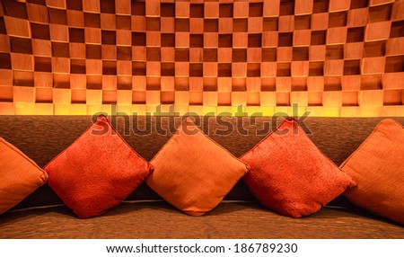 Silk pillow on soft sofa and wood cube wall