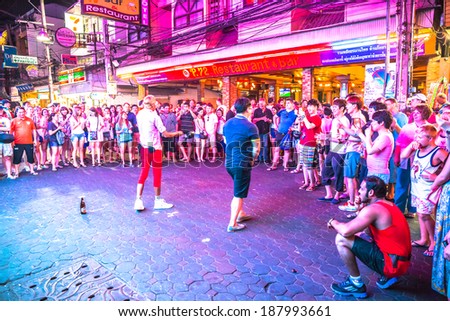 PATTAYA - APRIL 15: Crowd walking through the Walking Street on April 15, 2014 in Pattaya, Thailand. Its a tourist attraction primarily for night life and entertainment