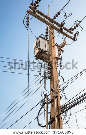 Distribution transformer box and electricity line on concrete pole