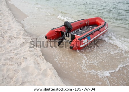 Red inflatable boat on beach