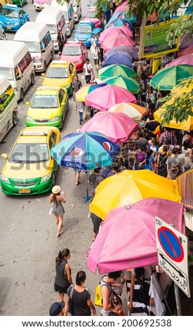 BANGKOK - JUNE 21:Cars, buses, taxis and people crowd on street at Chatuchak market Bangkok on June 21,2014.Chatuchak/Jatujak is the largest market in Thailand and the world\'s largest weekend market.