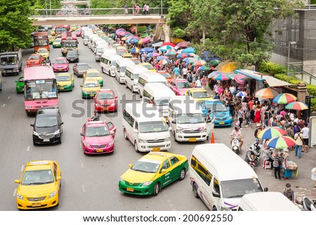 BANGKOK - JUNE 21:Cars, buses, taxis and people crowd on street at Chatuchak market Bangkok on June 21,2014.Chatuchak/Jatujak is the largest market in Thailand and the world's largest weekend market.