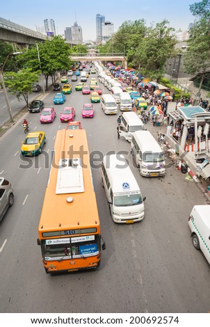 BANGKOK - JUNE 21:Cars, buses, taxis and people crowd on street at Chatuchak market Bangkok on June 21,2014.Chatuchak/Jatujak is the largest market in Thailand and the world\'s largest weekend market.