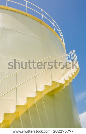 Big yellow tank in sunshine day