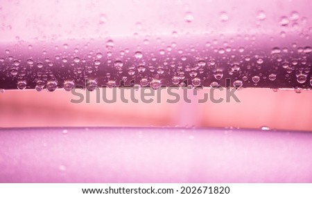 Water drops on metal surface texture in violet tone