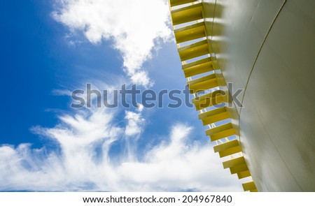 Big yellow tank and stair under blue sky