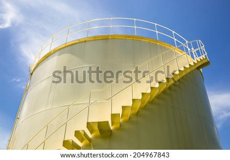 Big yellow tank under blue sky