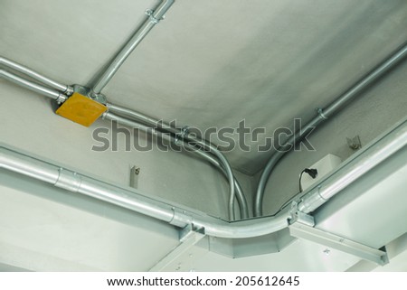Aluminum pipe of fire alarm system on bare concrete ceiling
