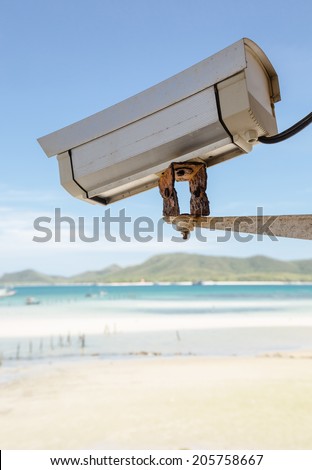 Security camera on rusty iron base at sea beach