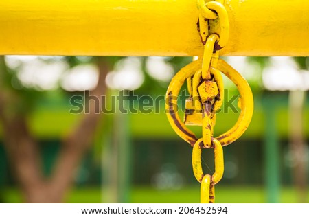 Yellow pipe bar and iron ring in park