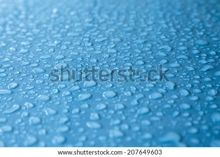 Rain drops on gray metallic surface
