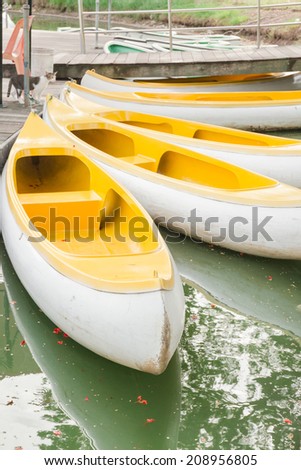 Yellow white canoe in green lake