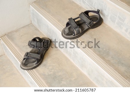 The old open-toe platform sandals on cement stair