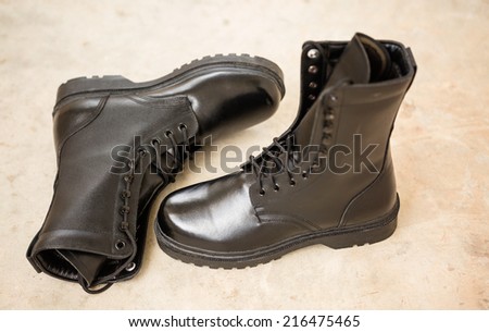 Black Leather Army Boots on blare cement floor