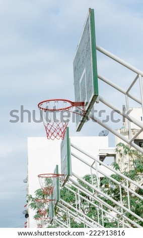 Basketball hoop on green wood and white iron structure base