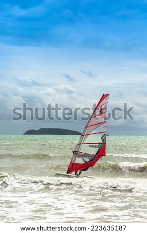 PATTAYA,THAILAND - 14 OCTOBER 2014: Windsurfing in sea bay in rainy season on October 14,2014 in Pattaya,Thailand.Pattaya city is famous about sea sport and night life entertainment.