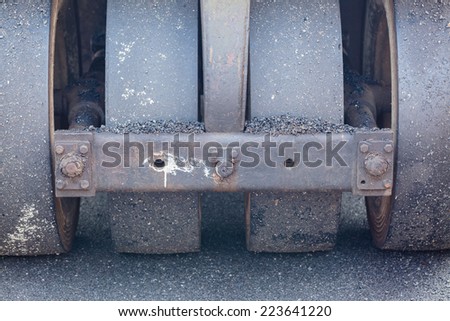 Metal roller compactor at asphalt pavement works for road repairing