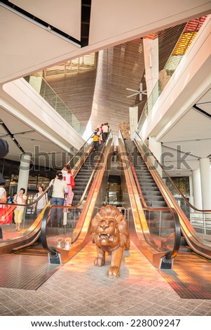 SINGAPORE-NOVEMBER 02:Carved lion wood at escalator and visitors are visiting the Flower Dome within the Gardens by the Bay in Singapore in November 02,2014