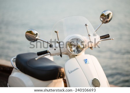 PATTAYA,THAILAND - DECEMBER 26 : New white Vespa  Italian designed scooter is parked on street along the sea at December 26, 2014 in Pattaya,Thailand