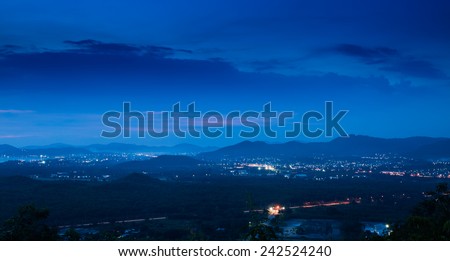 Small industrial city and hill in night time