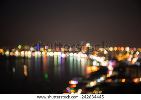 Defocused sea bay and  building of Pataya city in night time