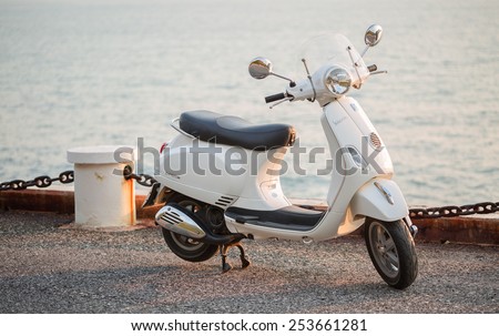 PATTAYA,THAILAND - FEBRUARY 17 : New white Vespa Italian designed scooter is parking on street along the sea at February 17, 2015 in Pattaya,Thailand