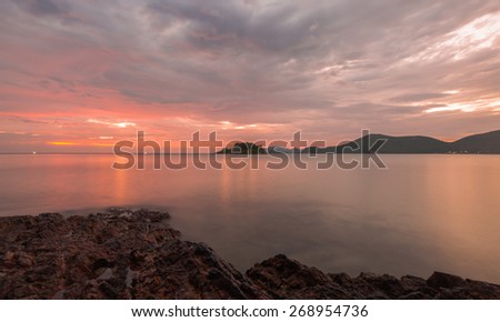 Seascape with cloudy sky before sunset