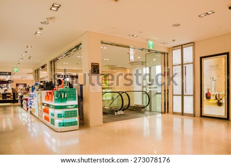 SEOUL,SOUTH KOREA - APRIL 14, 2015 : The escalator and shops inside of Dongwha duty free Department store in Seoul. There are lots of fashion shops i.e. cloths, cosmetic, watch etc.