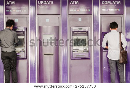 BANGKOK-APRIL,29 : The people are using purple Automatic Teller Machine of Saim commercial Bank on the side of main road on April 29,2015 in capital city Bangkok, Thailand