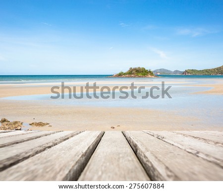 Planks of old wood on sea beach summer background