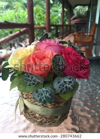 Colorful fabric rose on glass desk