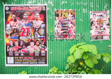 PHUKET, THAILAND - MAY 30: Thai boxing match poster on fence beside the street in city on May 30, 2015 in Phuket, Thailand.