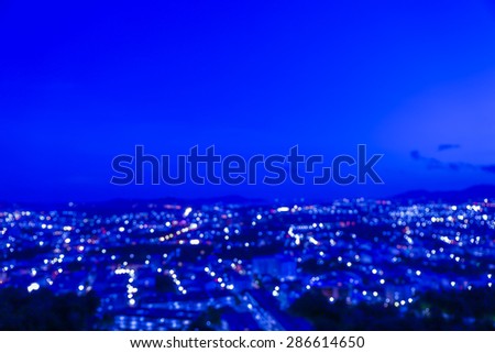 Out of focus small industrial city in night time