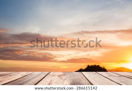 Wooden plates on golden sky before sun set background