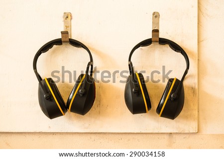 Ear protection hanging on wooden wall
