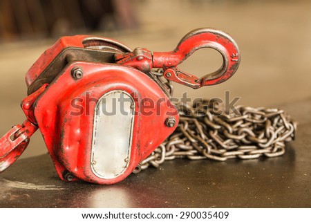 Red Industrial hook with chains on steel floor