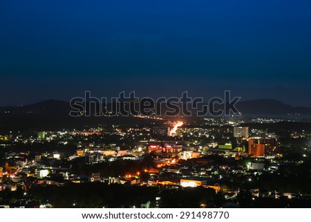 Lights and buildings of coastal city in night time