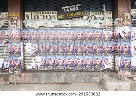 BANGKOK, THAILAND - JUNE 28 : Dirty wall  with posters advertising on old building  beside the street in down town on June 28, 2015 in Bangkok, Thailand.