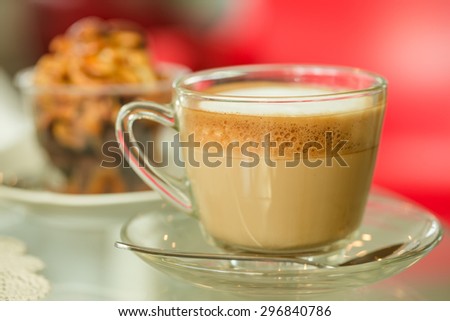 Glass hot coffee cup with white foam surface