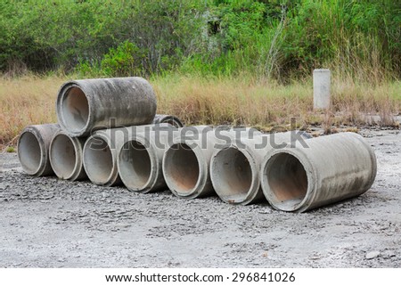 Concrete sewage pipes stored in a factory yard