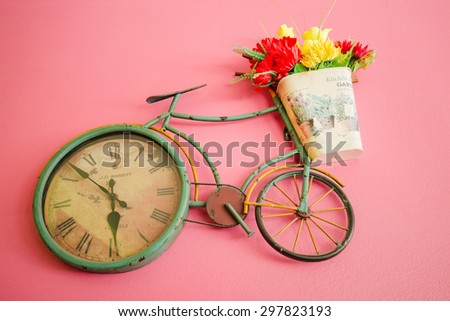PATTAYA, THAILAND - JULY 19 : The vintage architecture clock bicycle on pink wall in coffee shop on July 19, 2015 in Pattaya, Thailand.