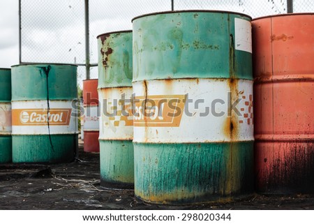 PATTAYA,THAILAND - JULY 20, 2015: The rusty oil barrel set in dirty floor in store of factory in Pattaya