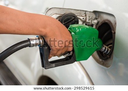 Closeup of pumping gasoline fuel into car tank