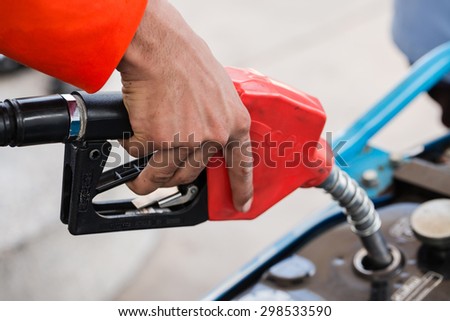 Closeup of pumping gasoline fuel into motorcycle tank